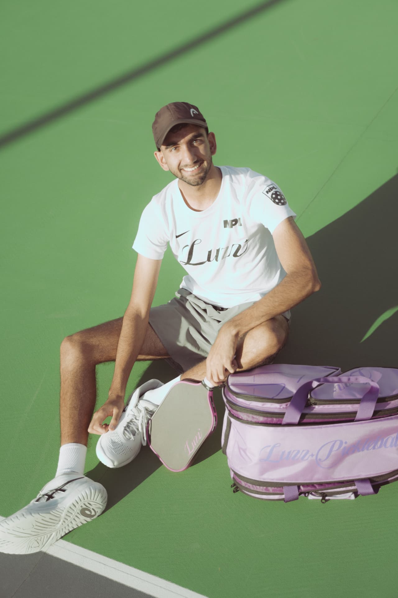 NPL player courtside with a Luzz paddle and Luzz pickleball bag