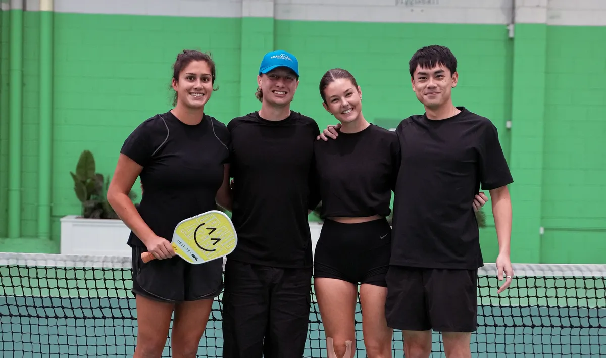Players in Make-A-Wish caps at the net during Pickleball for Wishes