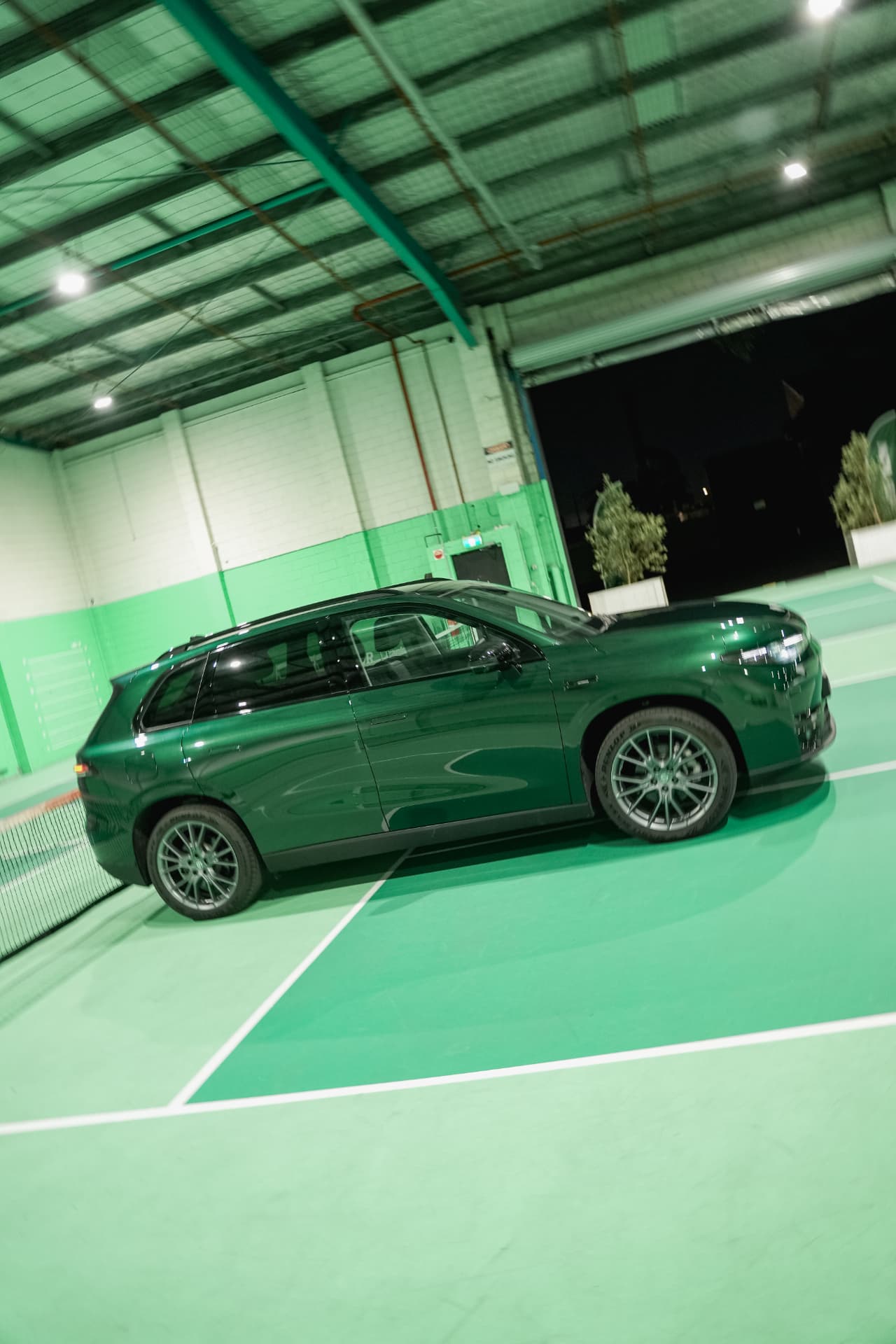 Side profile of a dark green Leapmotor C10 on the courts at The Jar HQ - Maidstone at night